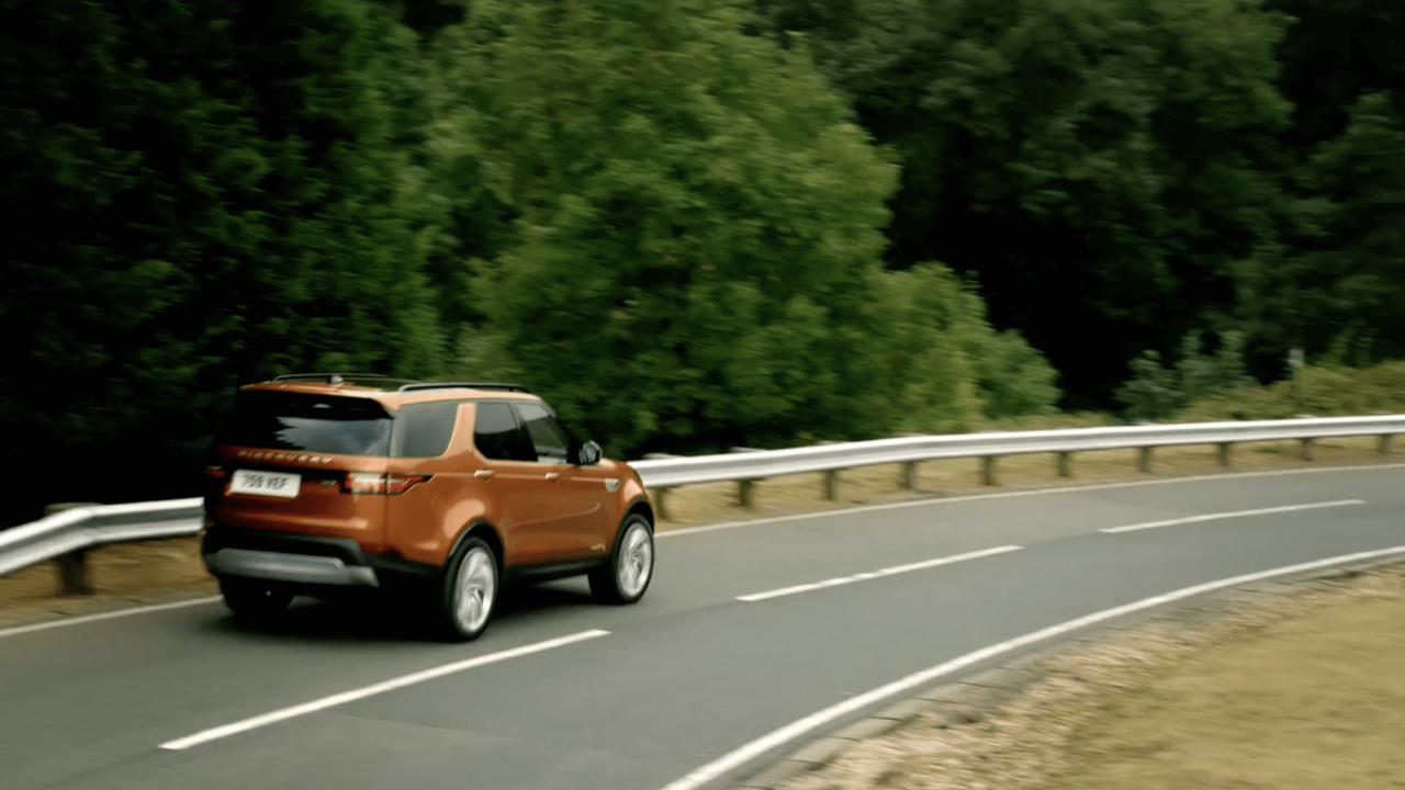 Land Rover Evoque driving around a corner in the forest